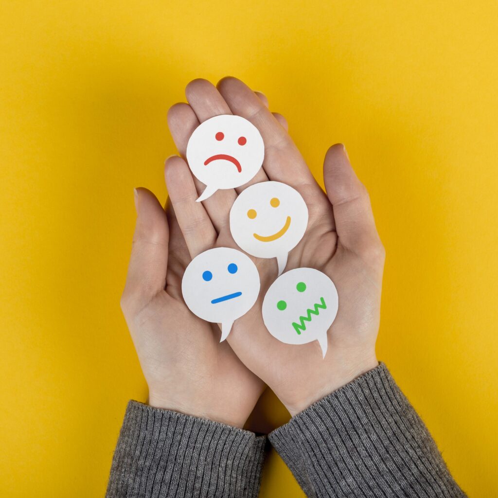 Mãos segurado desenhos de diferentes emoções